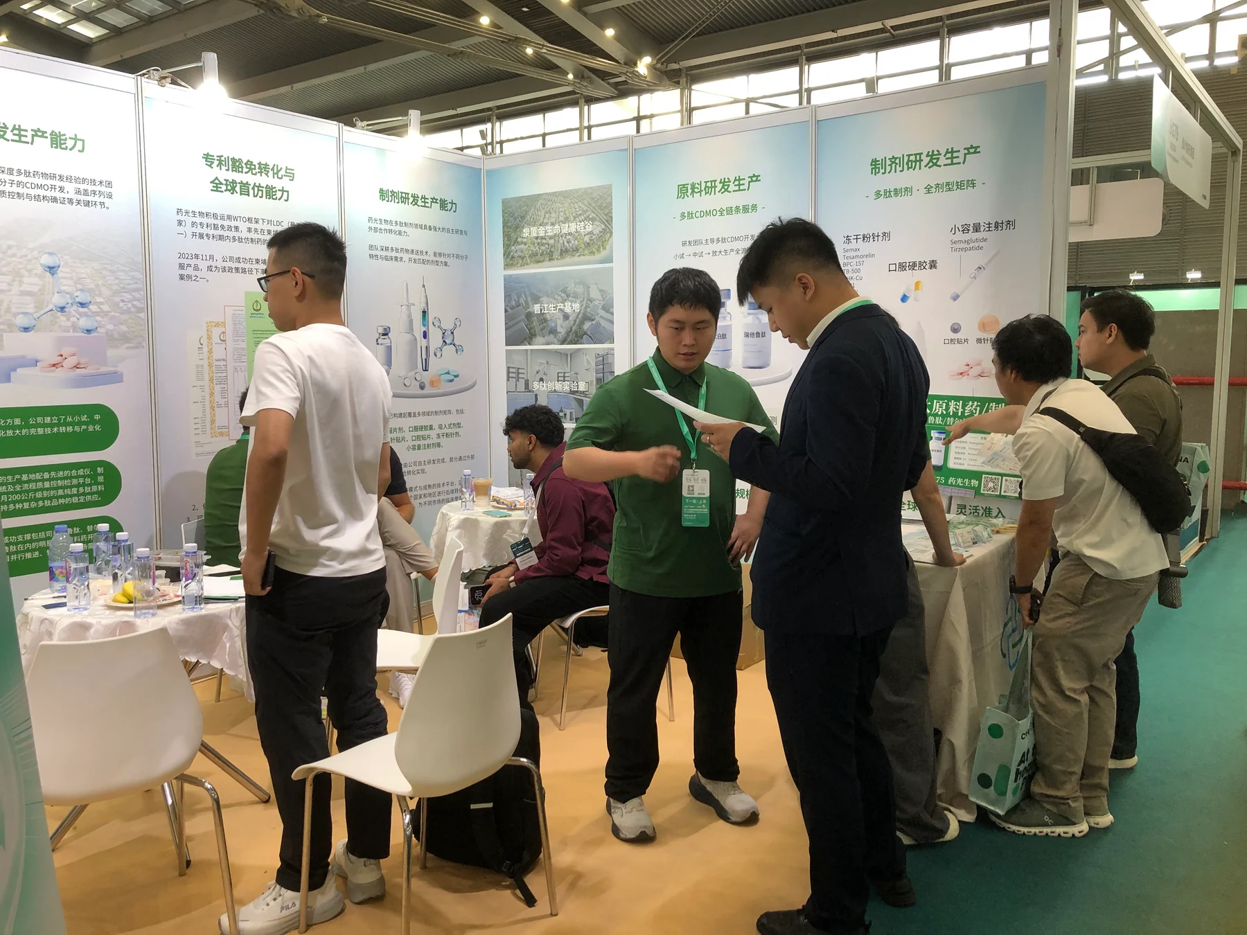 LUMIRABIO team reviewing public materials with visitors at the stand